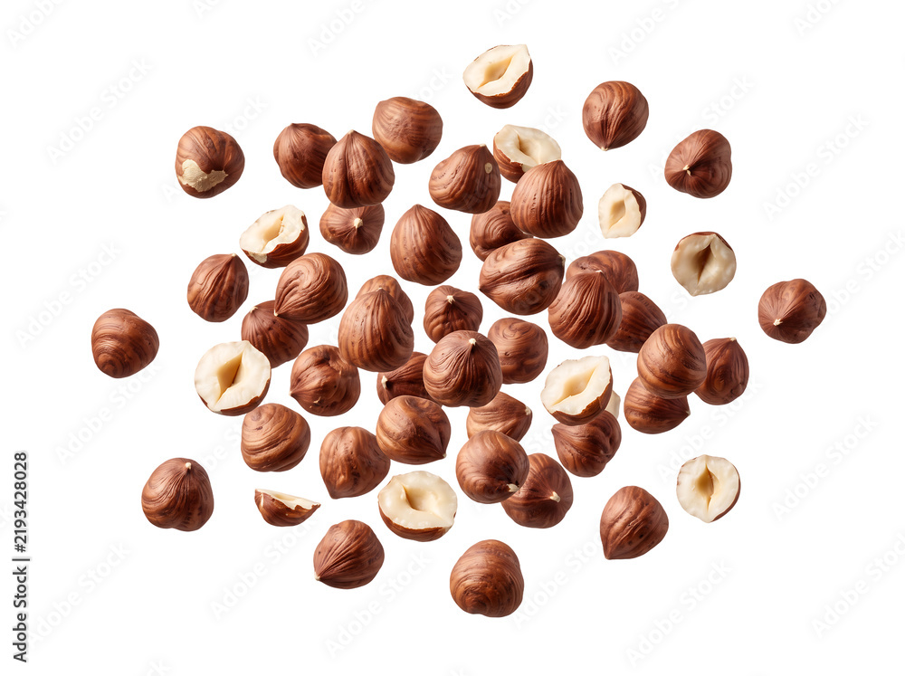 Obraz premium Scattered shelled hazelnuts with cut halves, organic raw filbert nut kernels isolated on transparent background