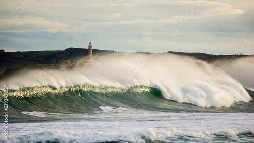 Фотография Huge Storm Wave Breaking Near Mouro Island Lighthouse in Santander, Spain
