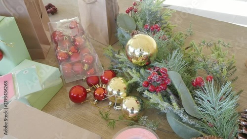 Christmas holiday gift wrapping and decorating supplies on table