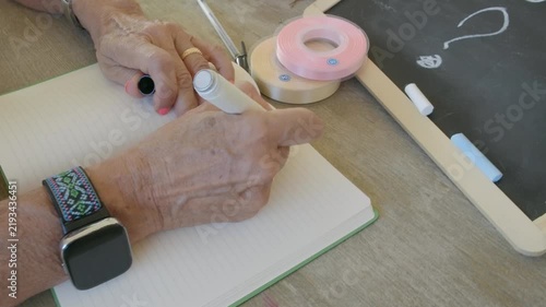 Elderly woman writing a to do list for 2027