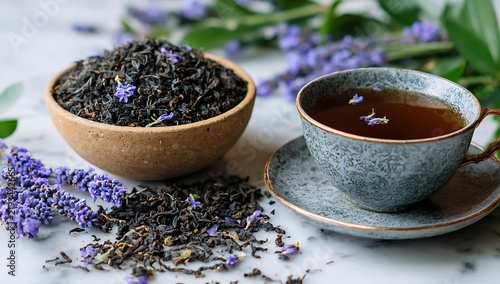 Handcrafted loose-leaf black tea with lavender steeped in ceramic cup on marble surface with fresh flowers
