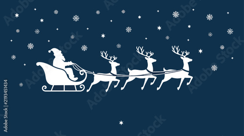 Santa claus riding in sleigh pulled by flying reindeer through falling snow at night