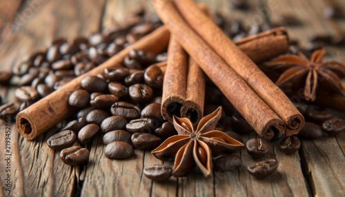 Cinnamon sticks and coffee beans arranged on a rustic wooden surface with star anise in a cozy kitchen setting