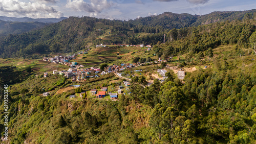 Aerial view of shola forest vegetation in Kookal, Palani Hills, Western Ghats, featuring Rudraksha, Jamun, cinnamon, grasslands, pine trees, and scattered village houses across the lush mountain lands