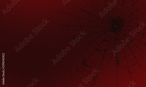 Foto A dark, eerie spider web silhouetted against a deep red, textured background, cr