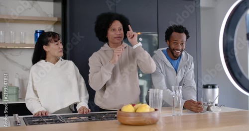 African American trio filming demo kitchen island ringlight phone recording leading right mixing