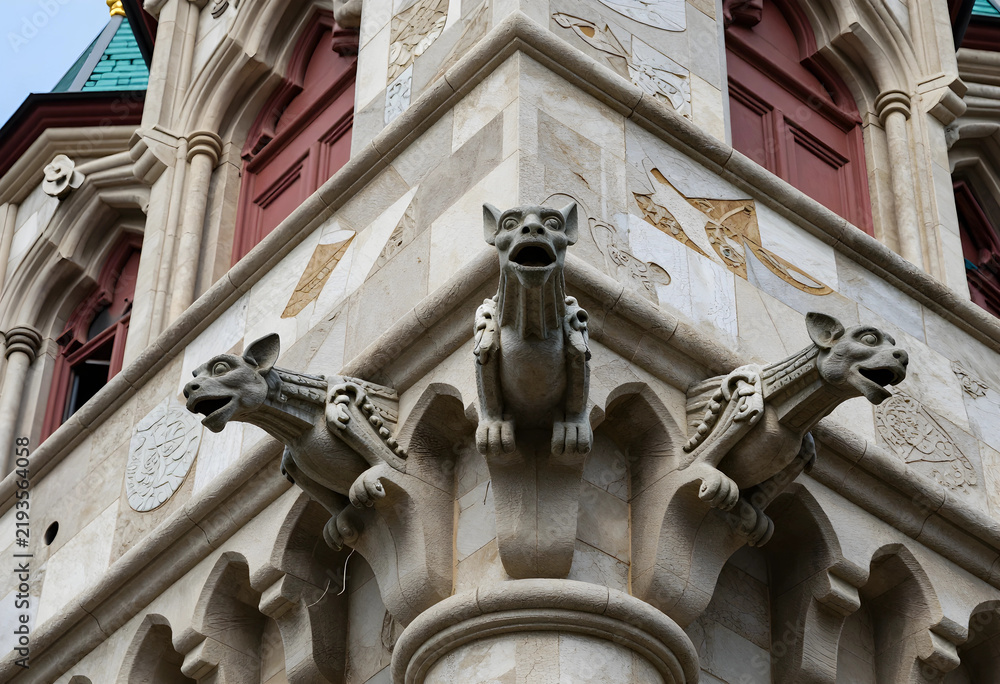 Obraz premium Gothic architecture and medieval history, stone gargoyles on historic building facade with intricate carvings and ornate masonry details in urban setting