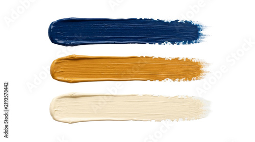Fotografie Three distinct paint strokes in navy blue, ochre, and cream on white
