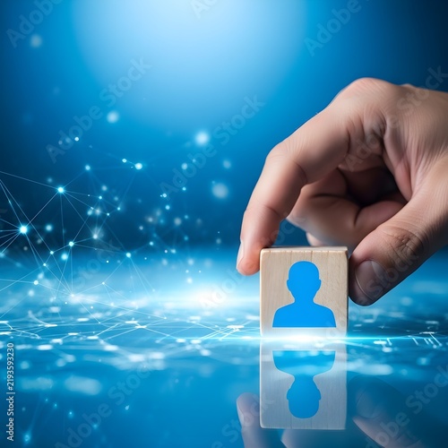 Hand placing digital human avatar icon into futuristic network interface concept with glowing blue technology background