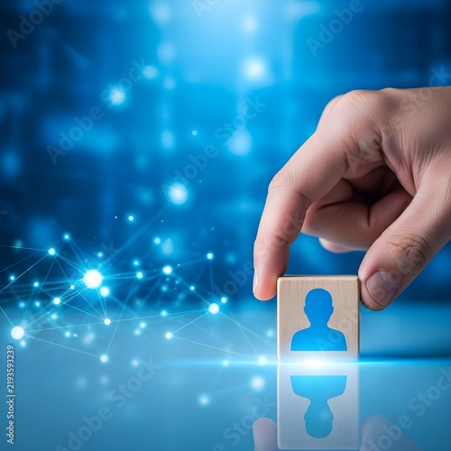 Hand placing digital user icon into network puzzle block on futuristic tech background