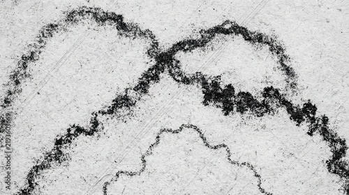 Abstract charcoal drawing with rough organic lines on textured paper