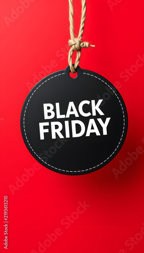 Black friday sale circle tag banner and hanging rope on red background. Sale banner template, close-up. White tone