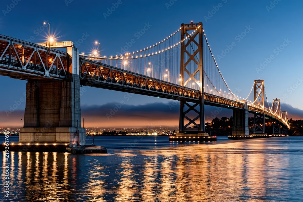 Fototapeta premium San Francisco Oakland Bay Bridge illuminated at night twilight skyline