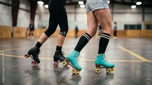 female legs in motion during roller skating session at outdoor court  
