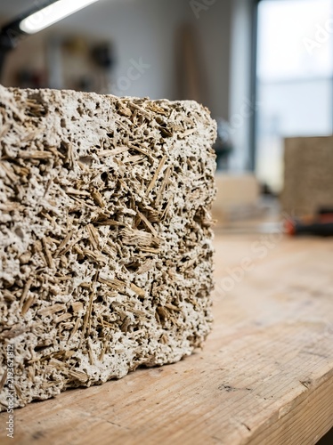 Bio based hempcrete construction block sample placed on wooden workbench