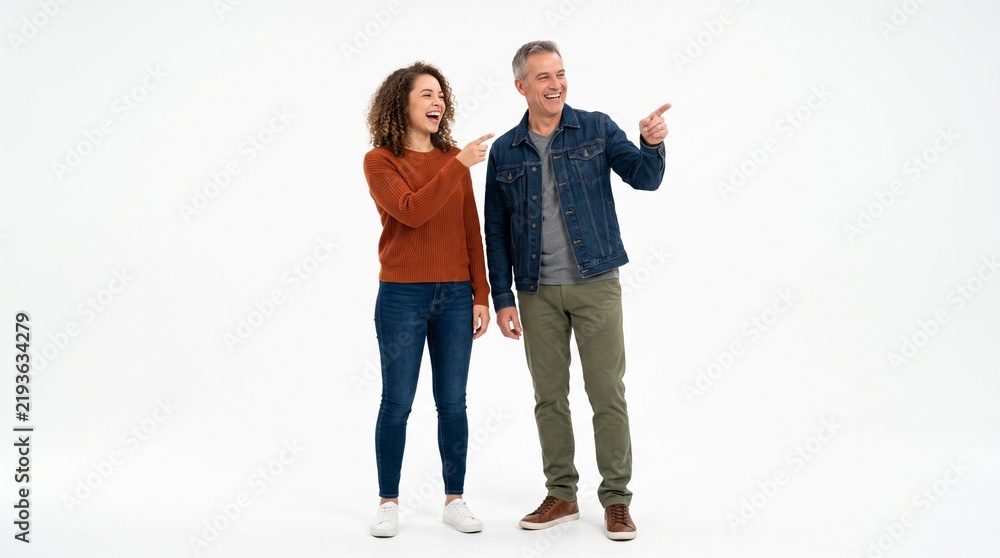 Obraz premium Cheerful man and woman pointing away while standing isolated on white background