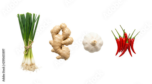 Obraz na płótnie Fresh green onions ginger root garlic bulb and spicy red chili peppers on transp