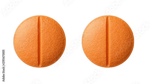 Foto Two round orange pills with a dividing line, isolated on transparent background