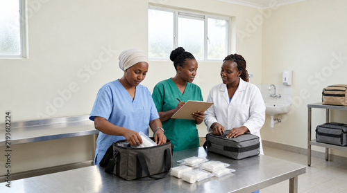 Health team organizing plain emergency supply bags in Africa