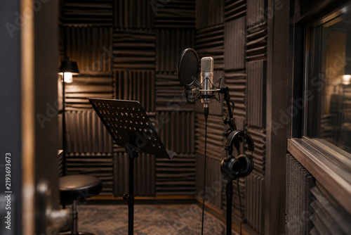 Recording studio isolation booth with walls covered in acoustic foam.