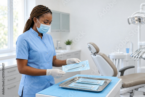 Dental professional preparing sealed instruments before a visit in Africa