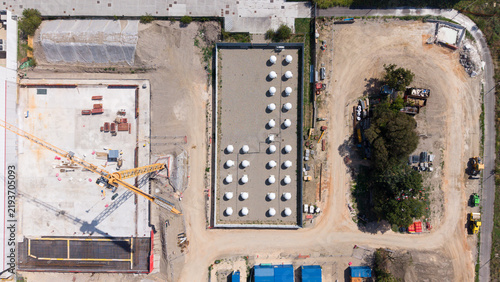 Aerial view of white antenna radomes arranged in a grid within an active industrial site near a data center construction project in Milan, Lombardy, Italy.