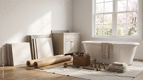 Minimalist bathroom renovation scene with white freestanding bathtub, marble tiles, flooring rolls, and brass fixtures in a sunlit interior room.