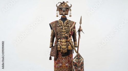 Elaborate traditional indigenous costume with ornate headdress, intricate patterns, and traditional weaponry, displayed on a mannequin, representing rich cultural heritage