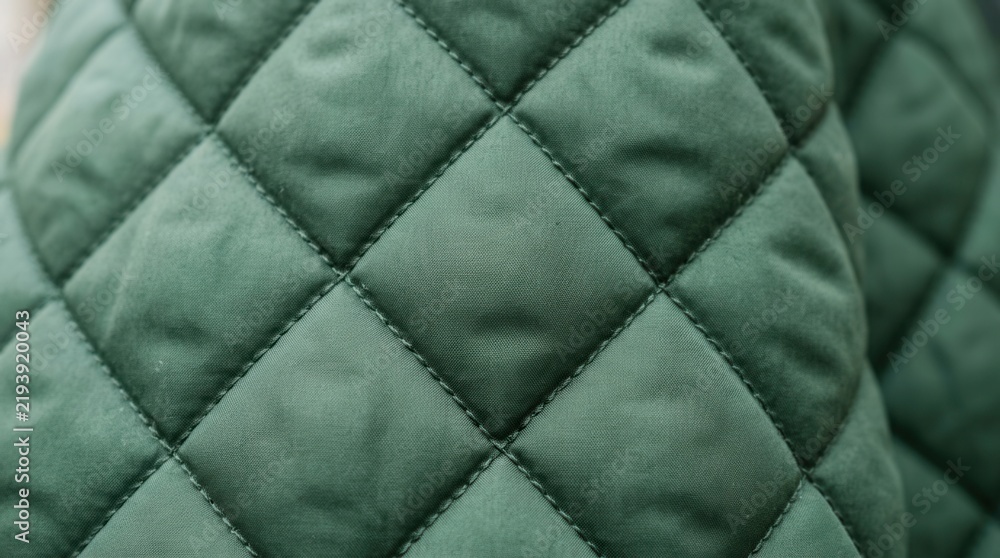 Obraz premium Close-up of Green Quilted Fabric with Diamond Pattern.
