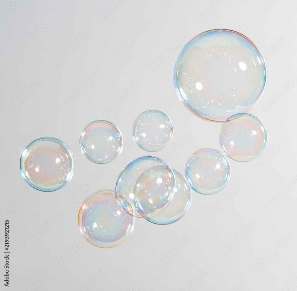 Obraz premium Colorful soap bubbles floating against white background