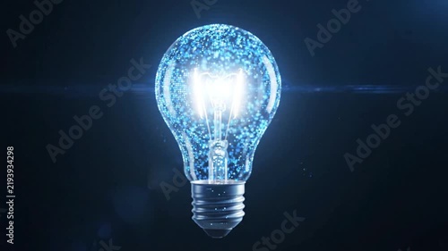 Glowing light bulb emitting sparkling blue digital particles in this fast motion animation video loop scene