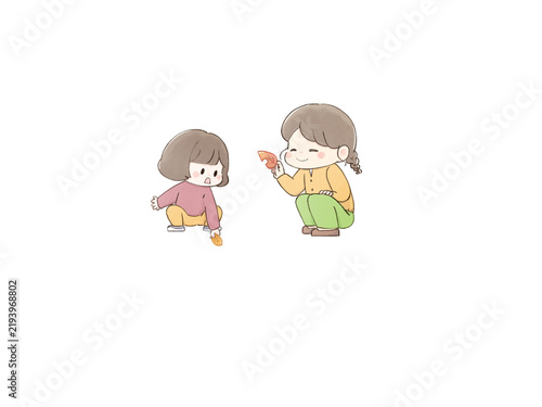 落ち葉を拾う親子