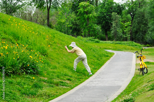 a young woman riding a bicycle in nature on a sunny day