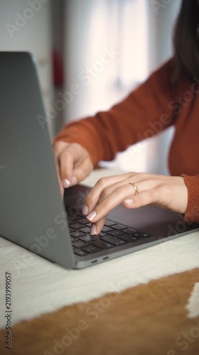Close-up video of an anonymous woman’s hands using a laptop in an office, highlighting professional work, technology, and digital productivity.
