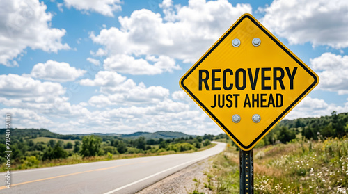 Yellow road sign indicating recovery ahead on rural highway
