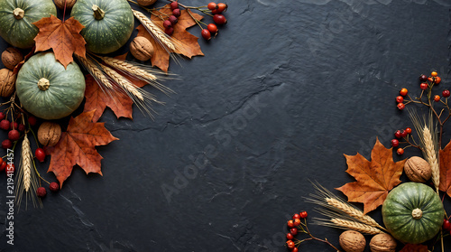 Pumpkins and foliage arrangement on dark slate background. autumn harvest still life with berries