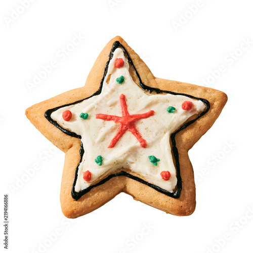 Decorated star shaped sugar cookie with white icing and red and green sprinkles