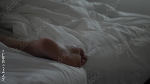 Quiet Morning, Close-Up of Bare Foot Resting on White Bed Sheets