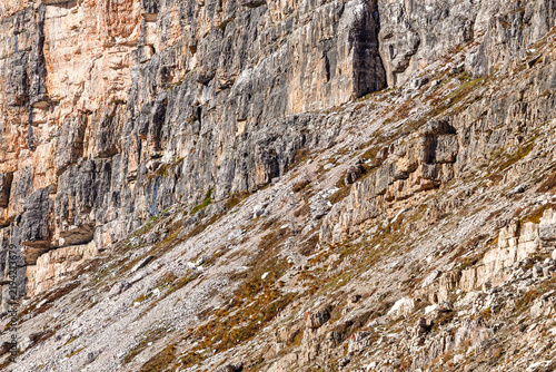 Obraz na plátne Rocky talus slope beneath towering cliffs in the Dolomites mountain