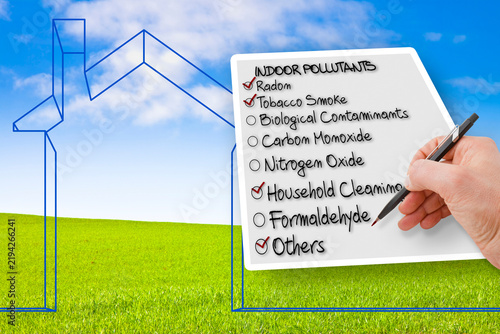 Cuadro en lienzo Hand writing a check list of indoor air pollutants against an outline of a littl