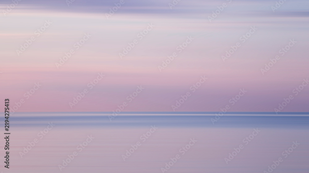 Obraz premium Blurred background sea and sky at sunrise. The sea and the sky are pearly. Beautiful backdrop for your design.
