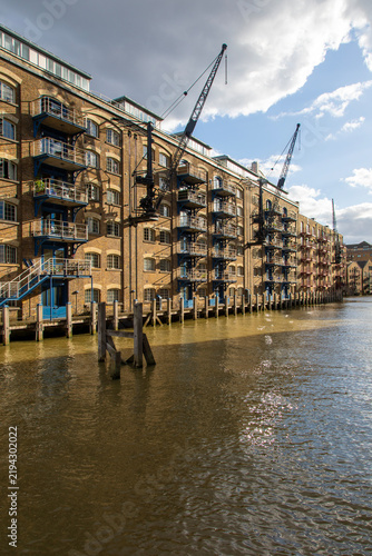 Картината върху платно Warehouses line St Saviour's Dock, the mouth of the River Neckinger where it mee
