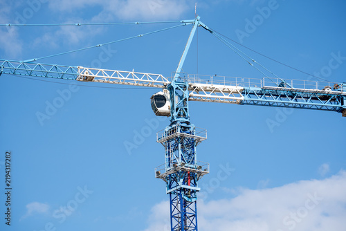 фотографія Construction Tower Crane Against Clear Blue Sky