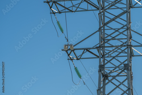 Canvastavla High voltage transmission tower close-up with steel lattice, ceramic insulators,