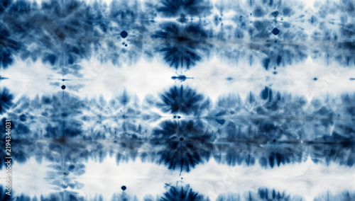 Indigo Dye Abstract: A mesmerizing abstract pattern created through the art of indigo tie-dyeing, featuring a beautiful blend of deep blue and white creating organic, floral-like motifs.