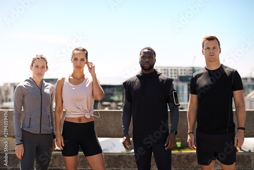 Portrait  athlete and group in city with fitness for challenge  competition or commitment for health. Runner  club and serious people with space for sports  workout or training together for marathon