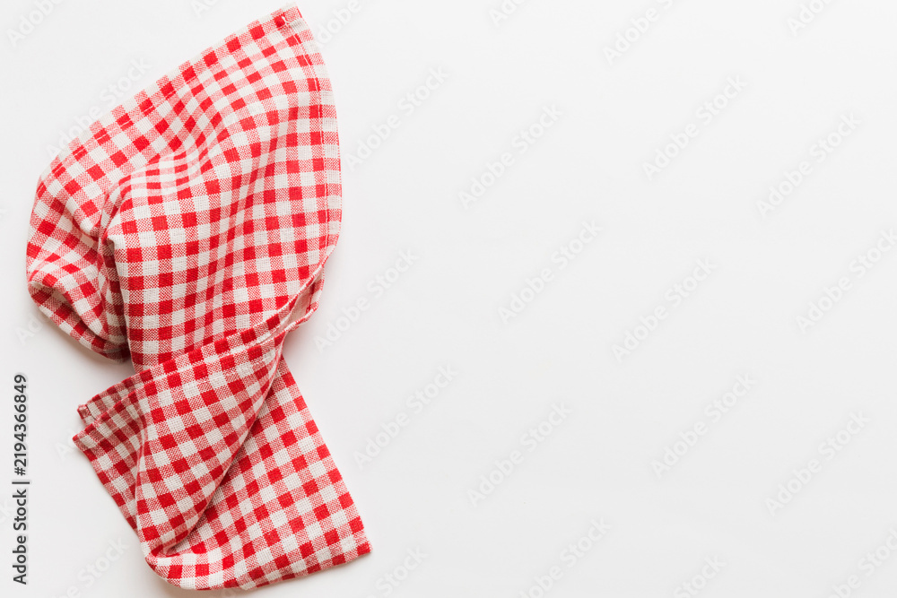 Obraz premium top view with red empty kitchen napkin isolated on table background. Folded cloth for mockup with copy space, Flat lay. Minimal style