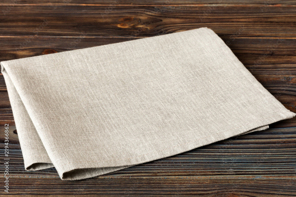 Obraz premium top view with gray kitchen napkin isolated on table background. Folded cloth for mockup with copy space, Flat lay. Minimal style