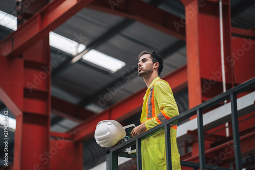 фотографія Technician Overseeing Operations in Modern Steel Factory Environment