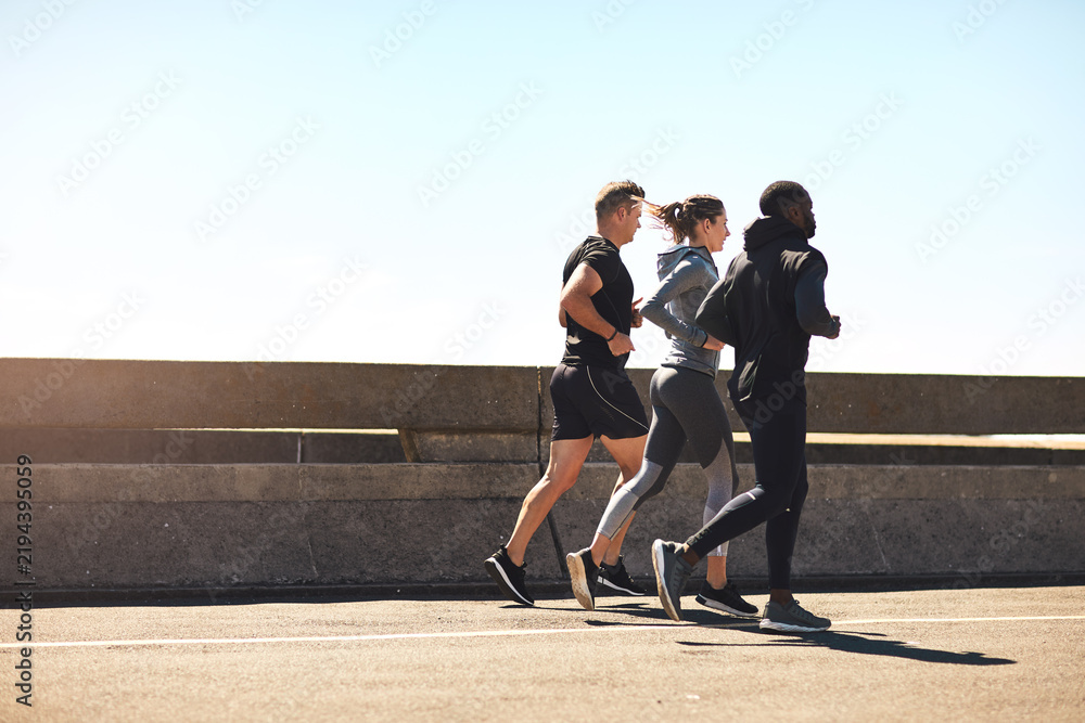 Fototapeta premium City, fitness and people running with space for marathon training, cardio and workout outdoor. Sports, athlete group or runner club with endurance, health and exercise for race preparation in street